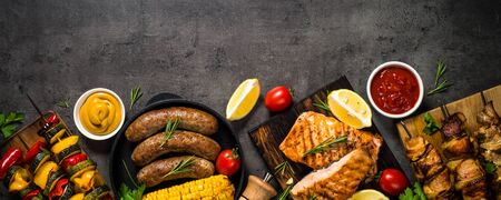 Grilled meat, fish, sausages and vegetables.の写真素材