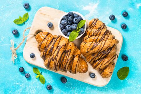 Croissant with fresh berries on blue.の写真素材