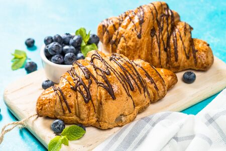 Croissant with fresh berries on blue.の写真素材