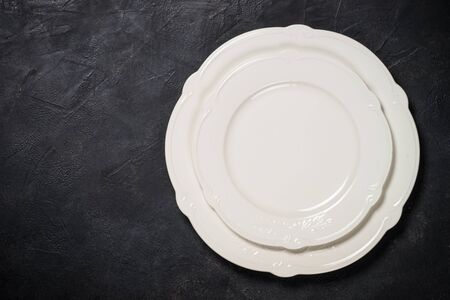 White plate on black stone table.