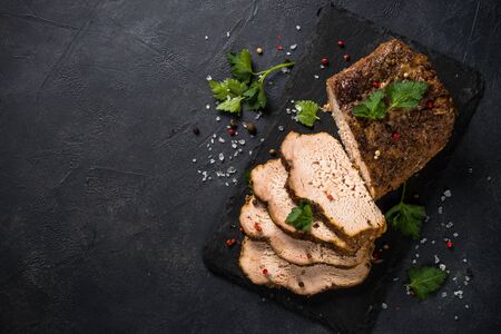 Baked pork meat ham on black kitchen table.の写真素材