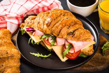 Croissant sandwich on black table.の写真素材