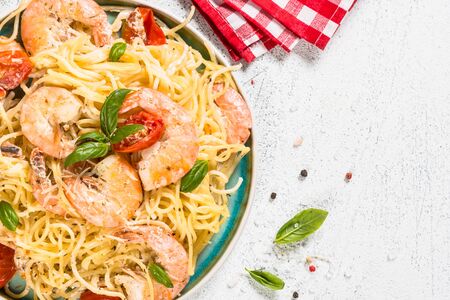 Pasta seafood. Spaghetti with shrimp and cream sauce. Top view on white table.の写真素材
