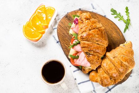 Croissant sandwich on white table.の写真素材