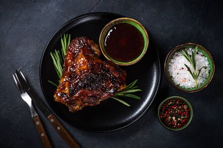 Baked turkey thigh with sauce and herbs.の写真素材