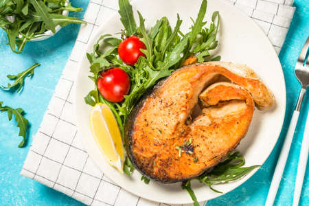 Salmon fish with fresh salad.