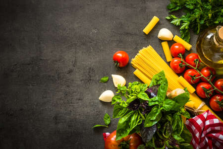 Italian food background on black table.の写真素材