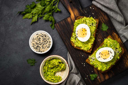 Avocado Sandwiches on black background.の写真素材