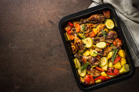 Baked chicken with vegetables preparing in the oven at baking sheet.の写真素材