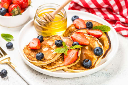 Pancakes with fresh berries and honey.の写真素材
