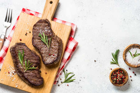 Grilled beef steak on wooden cutting board.の写真素材