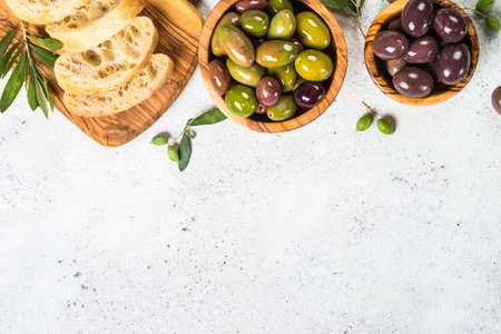 Olives, ciabatta and olive oil on white background.の写真素材
