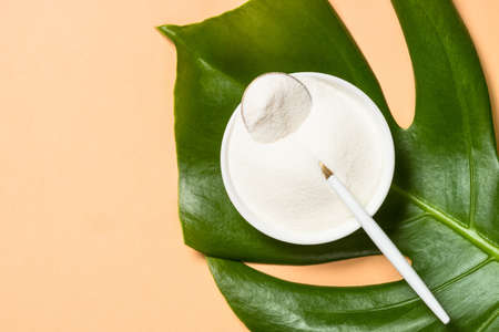 Collagen powder dietary supplement at pastel background.の写真素材