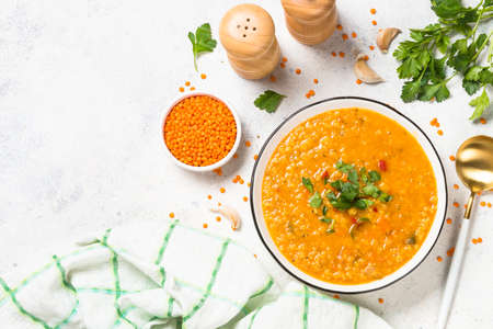 Lentil soup with vegetables at white stone table.の写真素材