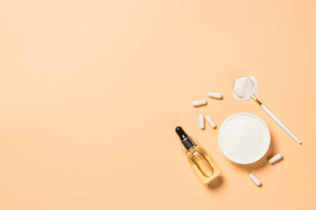Collagen powder dietary supplement at pastel background.