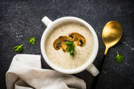 Mushroom Soup in craft bowl on dark stone table.の写真素材