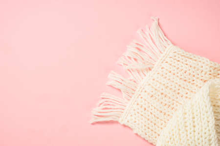 White scarf on a pink background. flat lay