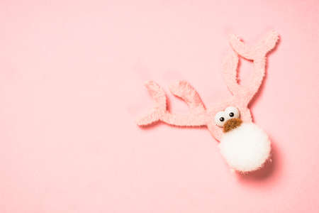 Fluffy holiday decoration at pink background.の写真素材