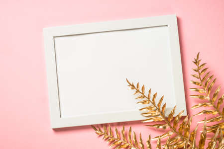 Christmas composition with golden christmas decorations at pink background.の写真素材