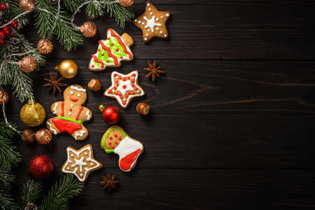 Christmas gingerbread in the plate with spices and decorations on dark wooden table.の写真素材