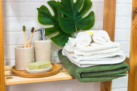 Bathroom with wooden shelving for cosmetic products and towels.の写真素材