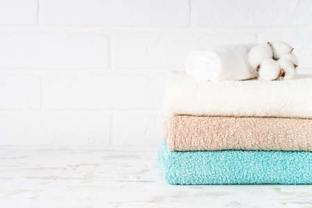Stack of bath towels in white bathroom.の写真素材