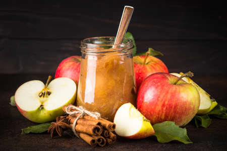 Apple jam with spices and fresh apples on dark background.の写真素材