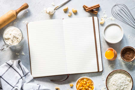 Baking background with cooking book and ingredients.