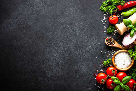 Food cooking background on black stone table.の写真素材
