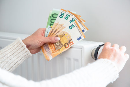 Radiator with thermostat and euro money banknotes.の写真素材