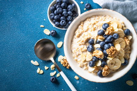 Oatmeal porrige in craft bowl at white background.の写真素材