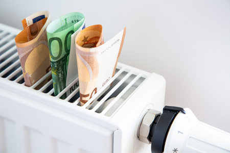 Radiator with thermostat and euro money banknotes.の写真素材