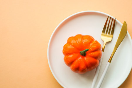 Autumn table setting. White plate, golden cutlery and fall decorations.の写真素材