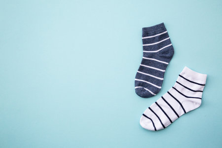Odd socks day concept. Mismatch socks at blue.の写真素材