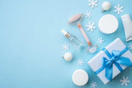 Winter cosmetic, gift and holiday decorations on blue.の写真素材
