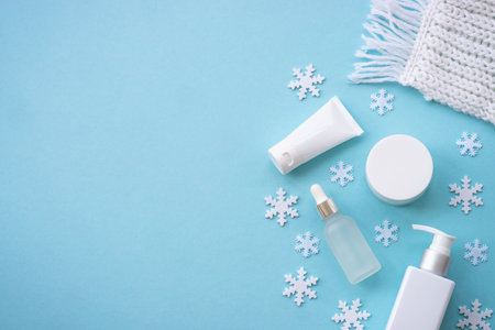 Winter cosmetic with holiday decorations on blue.の写真素材
