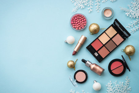 Winter cosmetic with holiday decorations on blue.の写真素材