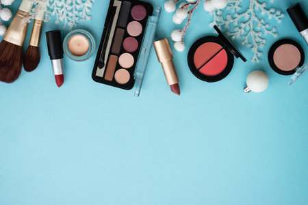 Winter cosmetic with holiday decorations on blue.の写真素材