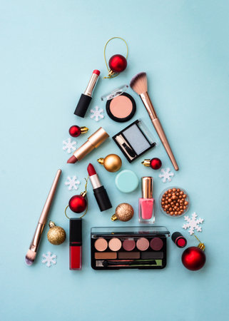 Christmas tree made from cosmetic and make up products on blue.の写真素材