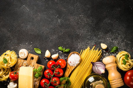 Pasta ingredients on black background top view.の写真素材