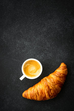 Croissant at black background top view.の写真素材