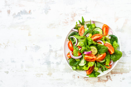 Fresh green salad with leaves and vegetables.の写真素材