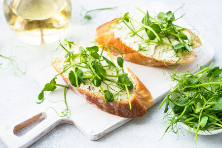 Toast with cream cheese and micro greens.の写真素材