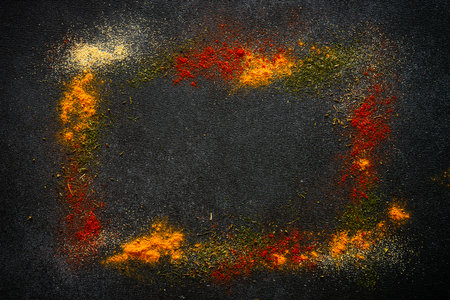 Spices powder on black slate background top view.の写真素材