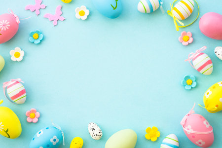 Easter background with Eggs and spring flowers at blue background.の写真素材