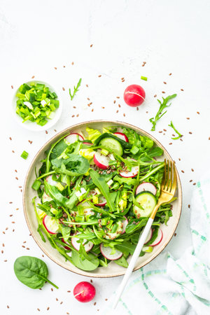 Green salad with spinach, arugula and radish with olive oil.の写真素材