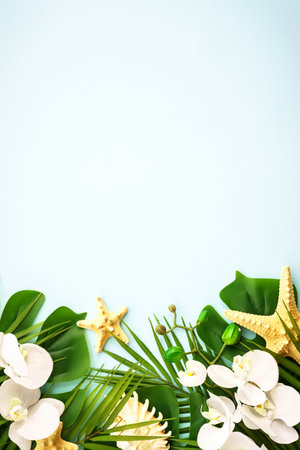 Tropical leaves, flowers and sea shells on blue.の写真素材