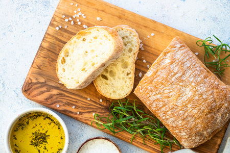 Italian ciabatta bread on olive board.の写真素材
