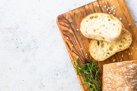 Italian ciabatta bread on olive board.の写真素材