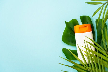 Sun screen skin care product on blue.